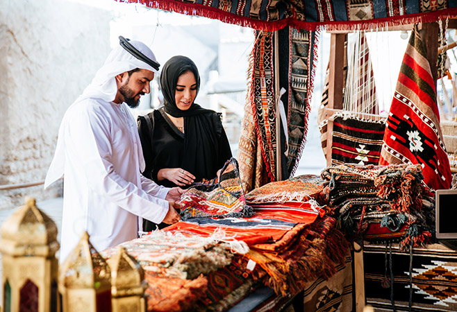 A couple exploring the cityscape respectfully, following Saudi Arabia’s cultural customs