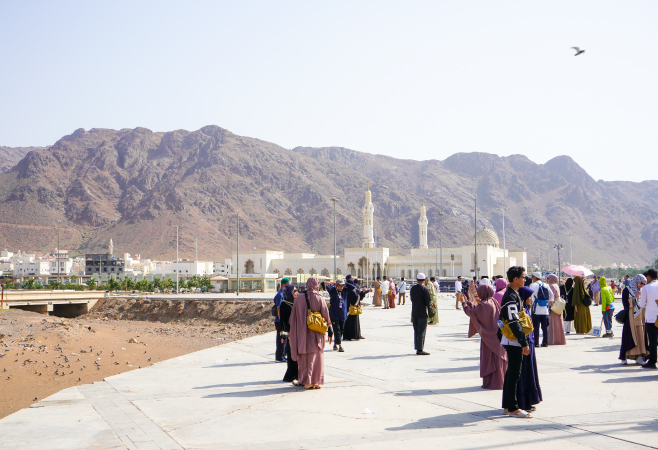 Visitors exploring the base of Mount Uhud