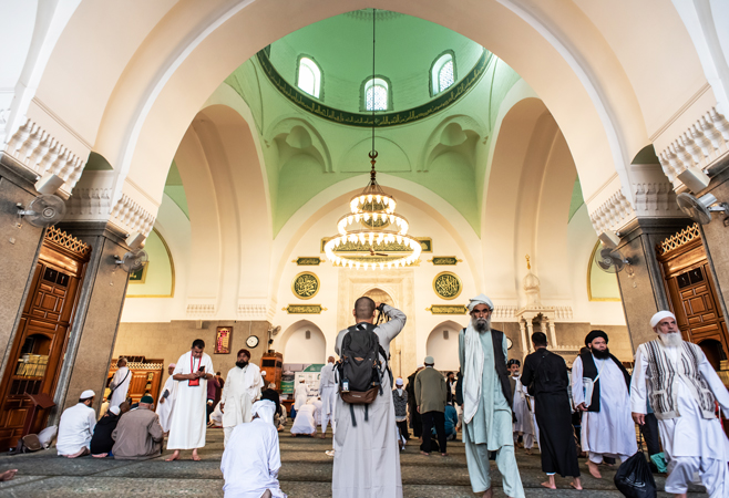 Worshippers praying inside Quba Masjid, embracing its serene atmosphere