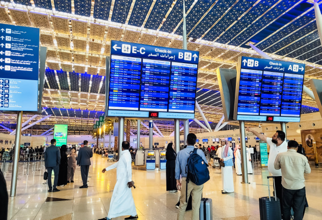 Passengers checking in at King Abdulaziz International Airport (Jeddah) departure hall.